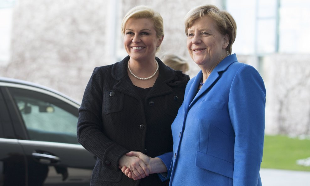 German Chancellor Angela Merkel welcomes Croatian President Kolinda Grabar-Kitarovic (L) at the Chancellery in Berlin, March 17, 2015. REUTERS/Axel Schmidt (GERMANY - Tags: POLITICS)