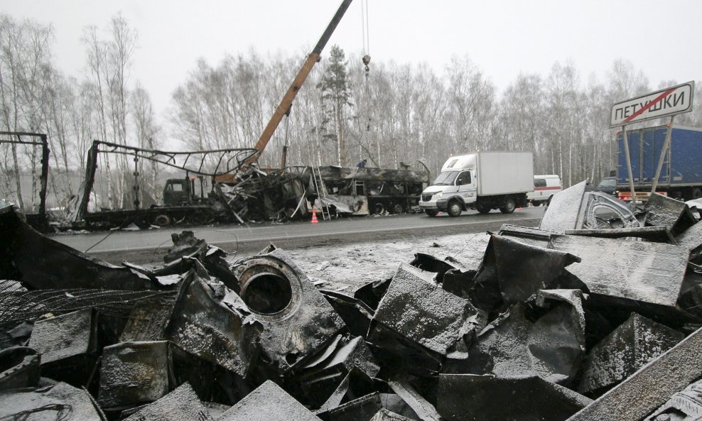 The destroyed cargo of a lorry is scattered across a road after it crashed with a bus outside the town of Petushki in Vladimir region, some 100km (62 miles) east of Moscow, March 26, 2009. Fourteen people were killed and four injured early Thursday when a