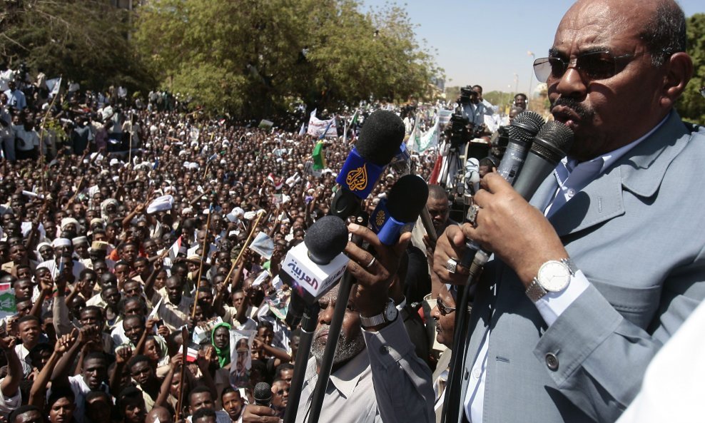 Sudan's President Omar Hassan al-Bashir delivers a speech to the crowd during a protest against ICC's arrest warrant for him in Khartoum March 5, 2009. Al-Bashir announced on Thursday that 10 foreign aid agencies had been expelled, in his first public res