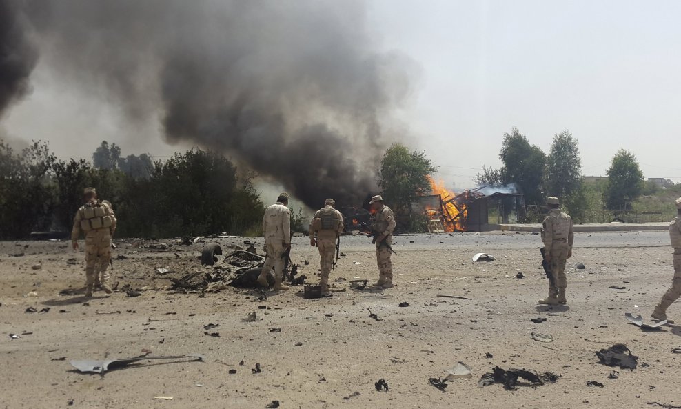 Iraqi security forces inspect the site of a car bomb attack on the outskirt of Diyala province
Iraqi security forces inspect the site of a car bomb attack on the outskirt of Diyala province May 24, 2015. The attack killed three civilians and wounded eigh