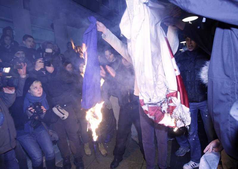 Police searching for protester who set EU flag on fire