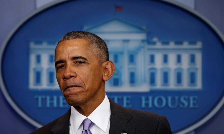 U.S. President Barack Obama appears to thank White House Spokesman Josh Earnest for his work during Earnest's last briefing at the White House in Washington, U.S., January 17, 2017. REUTERS/Kevin Lamarque