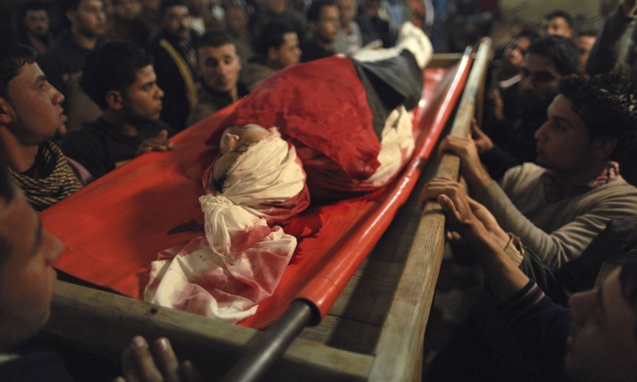 Palestinians carry the body of 20-year-old Mahmoud Zakot during his funeral in the northern Gaza Strip
