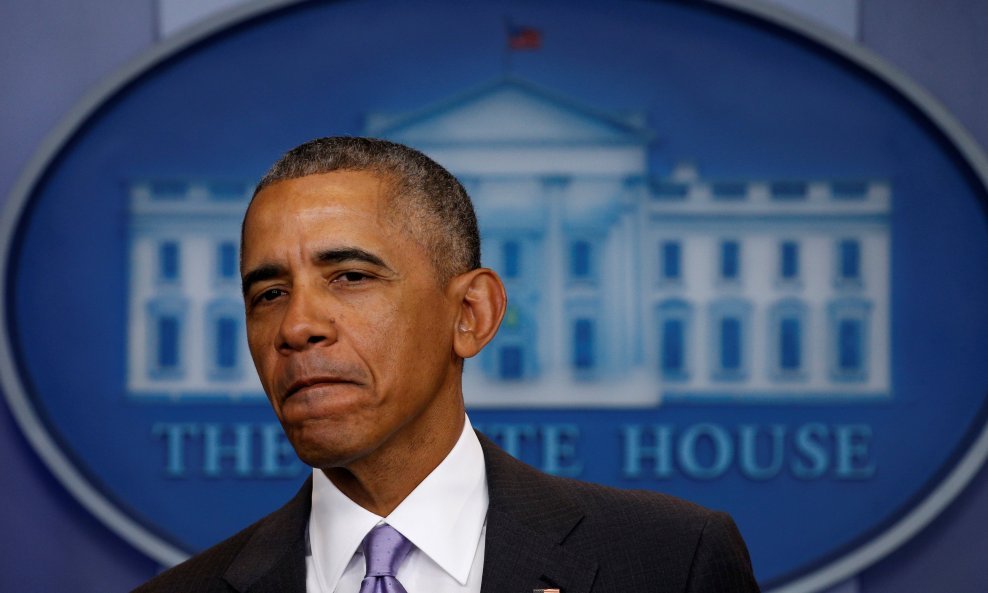 U.S. President Barack Obama appears to thank White House Spokesman Josh Earnest for his work during Earnest's last briefing at the White House in Washington, U.S., January 17, 2017.   REUTERS/Kevin Lamarque