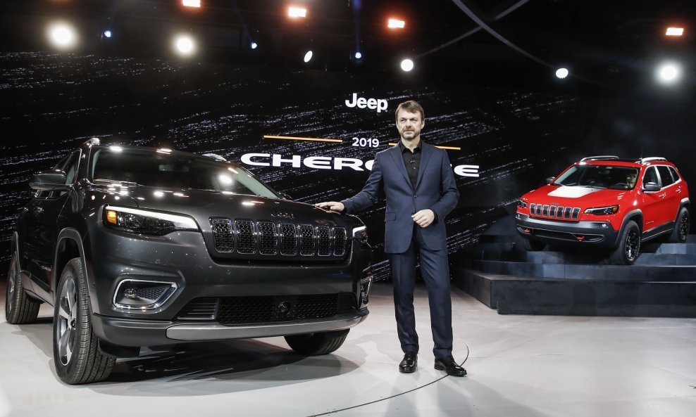 Mike Manley pozira s dva SUV-a Jeep Cherokee na međunarodnom sajmu automobila u Detroitu 2018.