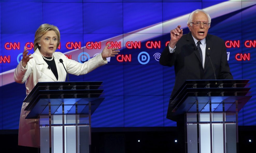 Hillary Clinton (L) and Senator Bernie Sanders 