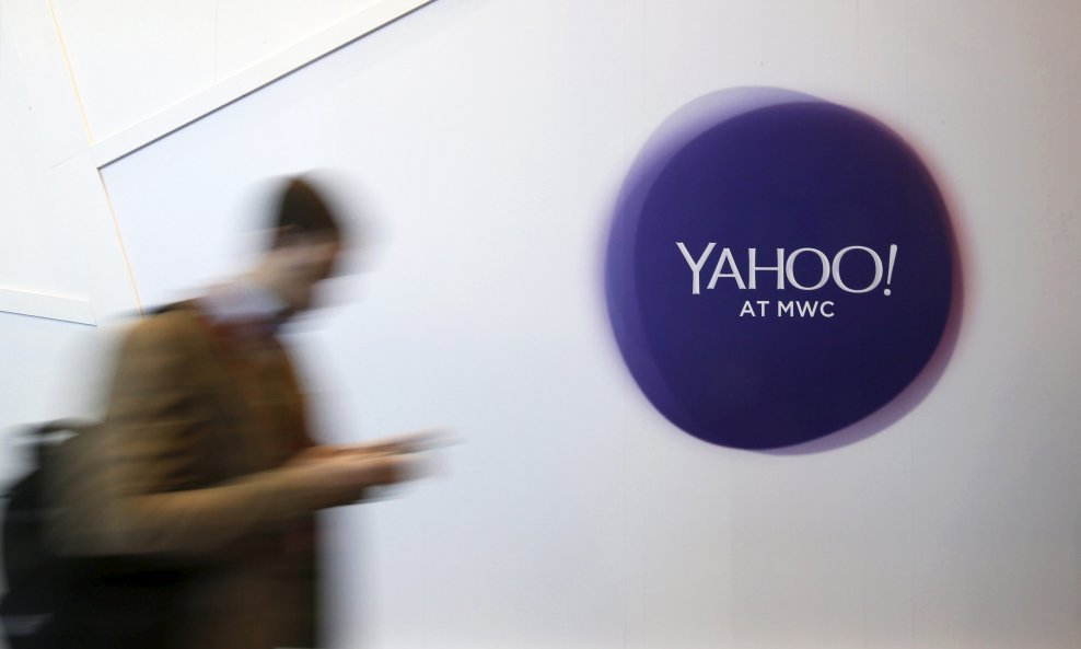 A man walks past a Yahoo logo during the Mobile World Congress in Barcelona, Spain in this February 24, 2016 file photo. REUTERS/Albert Gea/File Photo