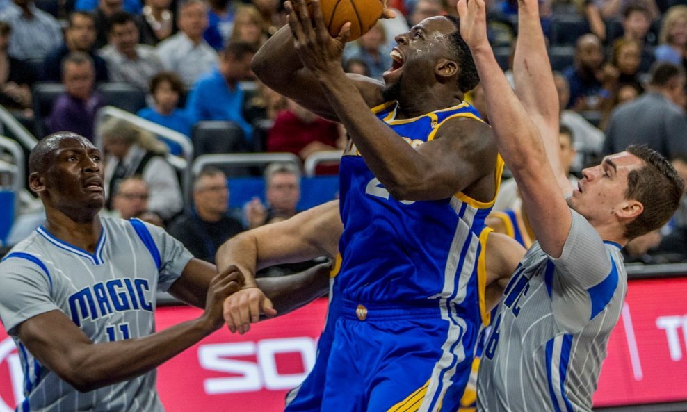 January 22, 2017: Golden State Warriors forward Draymond Green (23) attempts to score, while Orlando Magic center Bismack Biyombo (11) and Orlando Magic guard Mario Hezonja (8) defend the basket during a basketball game at Amway Center. Golden State Warri