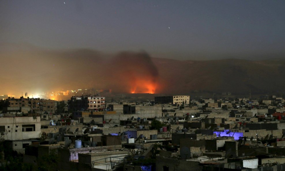 Smoke rises during clashes between forces loyal to Syria's President Bashar al-Assad and the Army of Islam fighters, on the eastern mountains of Qalamoun overlooking the town of Douma, eastern Ghouta in Damascus October 1, 2015. Picture taken October 1, 2