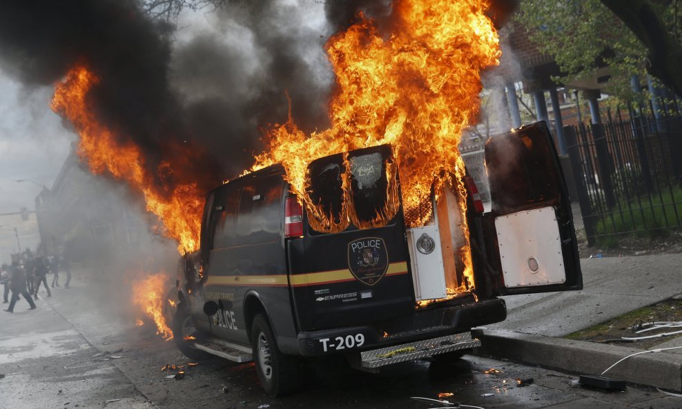 A Baltimore Metropolitan Police transport vehicle burns during clashes in Baltimore, Maryland April 27, 2015. Maryland Governor Larry Hogan declared a state of emergency and activated the National Guard to address the violence in Baltimore, his office sai
