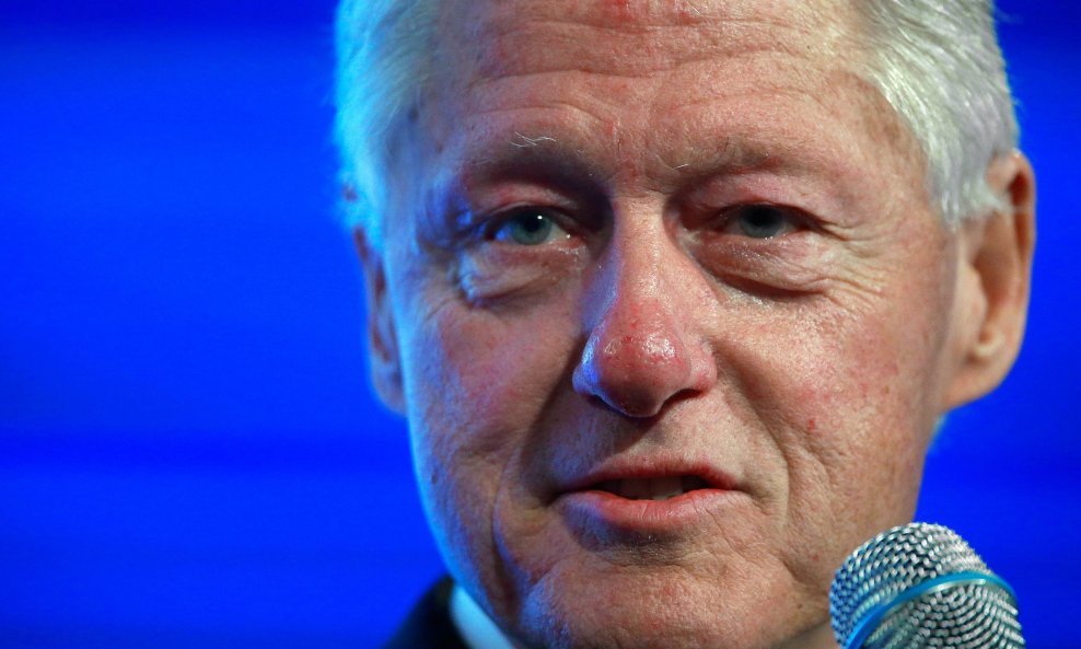 Former U.S. President Bill Clinton sits for an onstage interview during the 2014 Peterson Foundation Fiscal Summit in Washington, in this May 14, 2014 file photo. Clinton said on May 4, 2015 he will continue to give paid speeches while his wife, Hillary C