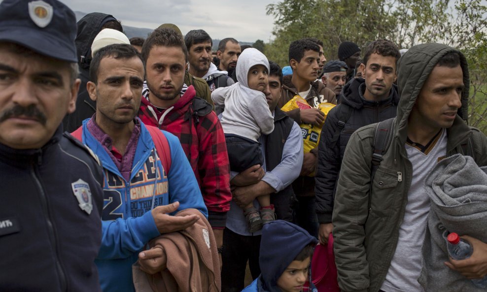 Migrants wait to be checked by Serbian police after crossing the border from Macedonia, at Miratovac, Serbia October 15, 2015. REUTERS/