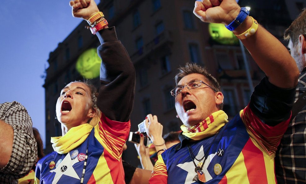 unts Pel Si (Together For Yes) supporters wear pro-independence "Estelada" flag shirts during a gathering to follow election results after polls closed in a regional parliamentary election in Barcelona, Spain, September 27, 2015. Separatists have won a cl