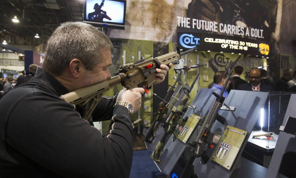 Mark Heitz, of Tactical Firearms in Kingston, New Hampshire, looks over a civilian version of the Colt M4 carbine during the annual SHOT (Shooting, Hunting, Outdoor Trade) Show in Las Vegas, in this file photo taken January 15, 2013. Famed U.S. gun maker 