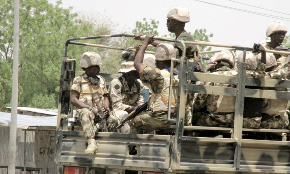 Soldiers are seen on a truck in Maiduguri in Borno State, Nigeria May 14, 2015. At least six civilians and six members of a youth vigilante group were killed in an attack by Boko Haram militants on Nigeria's northeastern city Maiduguri, two military sourc