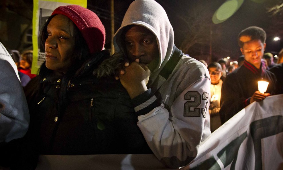 Tramale Robinson rests on the shoulder of his mother Lynn Robinson (L) during a candlelight vigil for Tony Robinson Jr. in Madison, Wisconsin March 8, 2015. Activists protested for a third day in Madison, Wisconsin, on Sunday over the fatal shooting of an