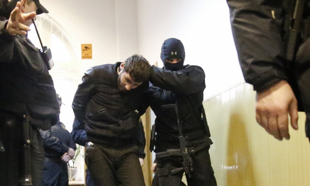 Zaur Dadayev (C), charged with involvement in the murder of Russian opposition figure Boris Nemtsov, is escorted in a court building in Moscow, March 8, 2015. Moscow authorities have charged two men with involvement in the murder of Kremlin critic Boris N