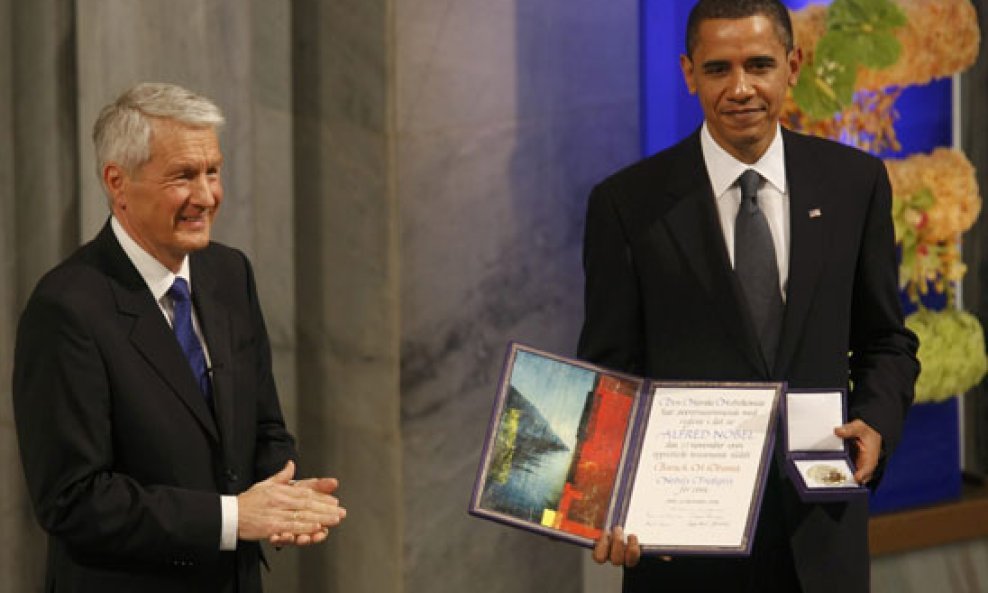 The Norwegian Nobel committee chairman Thorbjoern Jagland applauds 