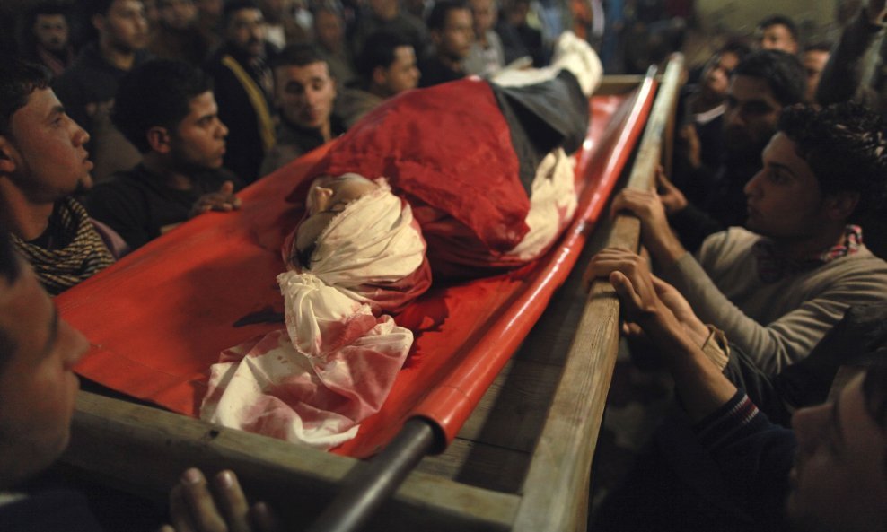 Palestinians carry the body of 20-year-old Mahmoud Zakot during his funeral in the northern Gaza Strip