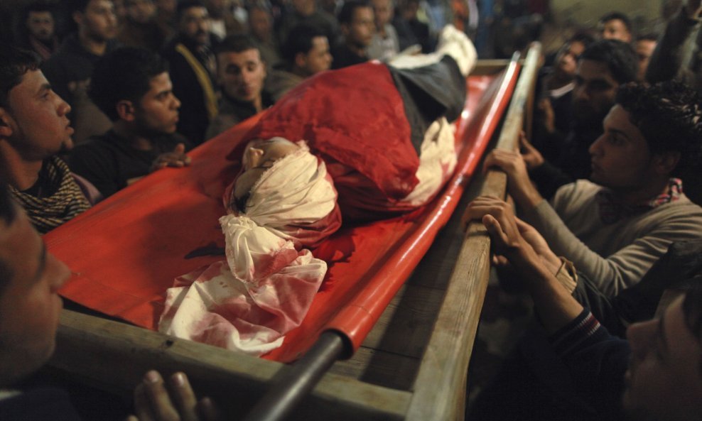 Palestinians carry the body of 20-year-old Mahmoud Zakot during his funeral in the northern Gaza Strip