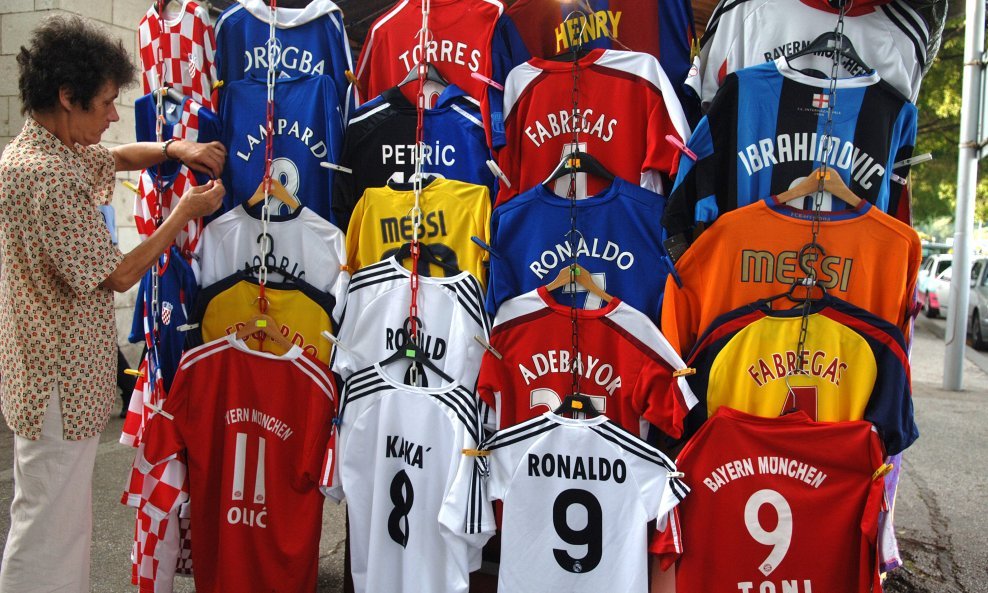 Prodavačica nogometnih dresova (sportskih majica) u splitskoj trajektnoj luci izložila je bogatu ponudu istih. Može se, primjerice, kupiti Realov dres Kake, Bracelonin Messija..., ali i dresovi igrača koji su ih već zamijenili novima - Ibrahimović (Inter)
