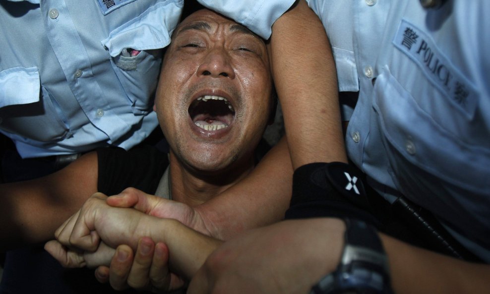 Policija u Hong Kongu privodi prosvjednika na demonstracijama za poboljšanje stanja ljudskih prava u Kini, na dan kada se u Pekingu službeno slavi 60. rođendan Narodne Republike Kine. Foto: Tyrone Siu/Reuters