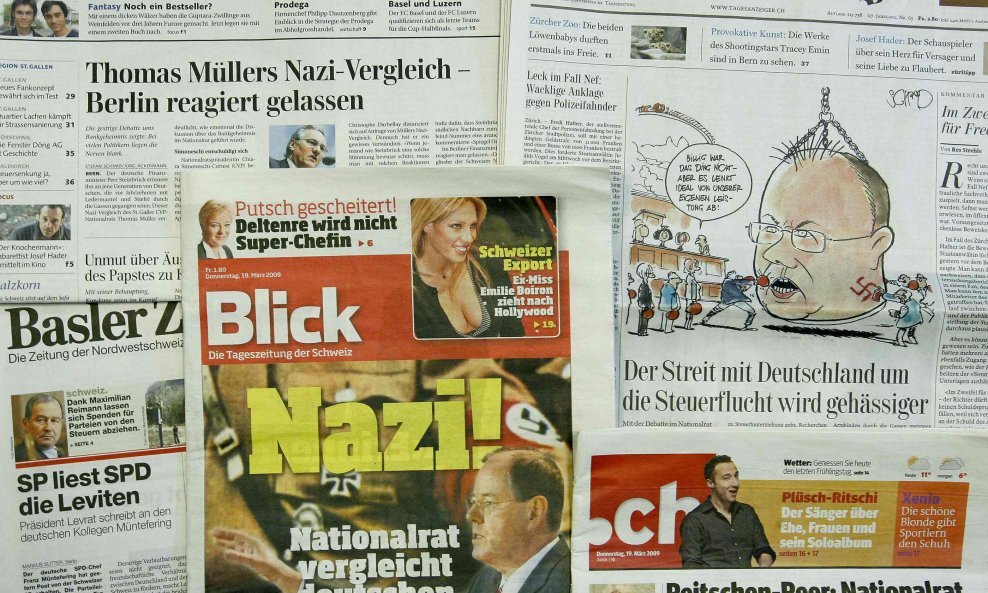 A picture shows the front pages of several Swiss newspapers headlined with the dispute between Switzerland and Germany after a Swiss national councillor compared German Finance Minister Peer Steinbrück with a Nazi, in Zurich March 19, 2009.  A diplomatic 