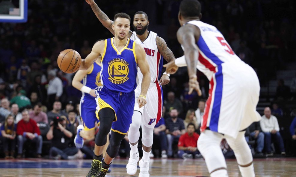 Dec 23, 2016; Auburn Hills, MI, USA; Golden State Warriors guard Stephen Curry (30) dribbles the ball between Detroit Pistons forward Marcus Morris (behind) and guard Kentavious Caldwell-Pope (5) during the first quarter at The Palace of Auburn Hills. Man