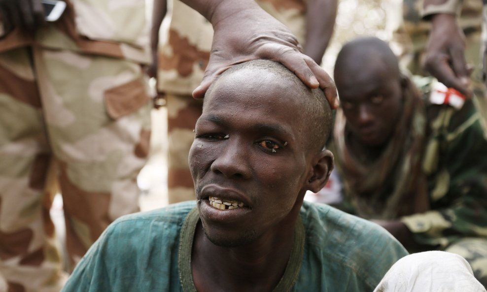 A man, whom the Chadian military say they have taken prisoner for belonging to insurgent group Boko Haram, is seen in Gambaru February 26, 2015. The Chadian military nicknamed the man the Butcher