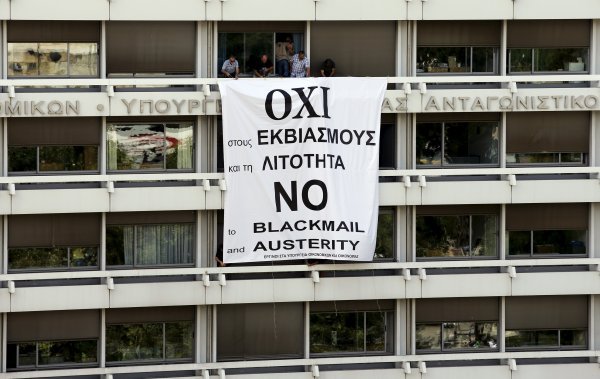 Djelatnici grčkog Ministarstva financija i nacionalne ekonomije postavljaju plakat povodom nedjeljnog referenduma, a strani mediji nagađaju da bi Cipras mogao odustati od njega 